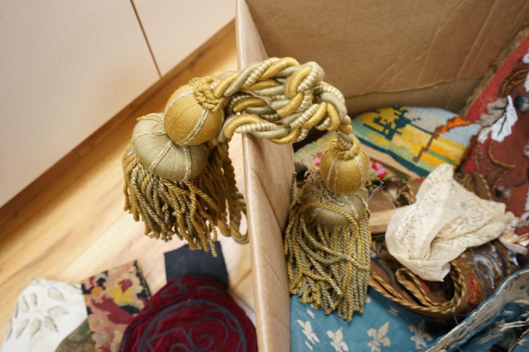 A 19th century beadwork panel and bell pull, various samples of printed textiles, a collection of corded and tasselled tie backs, etc.